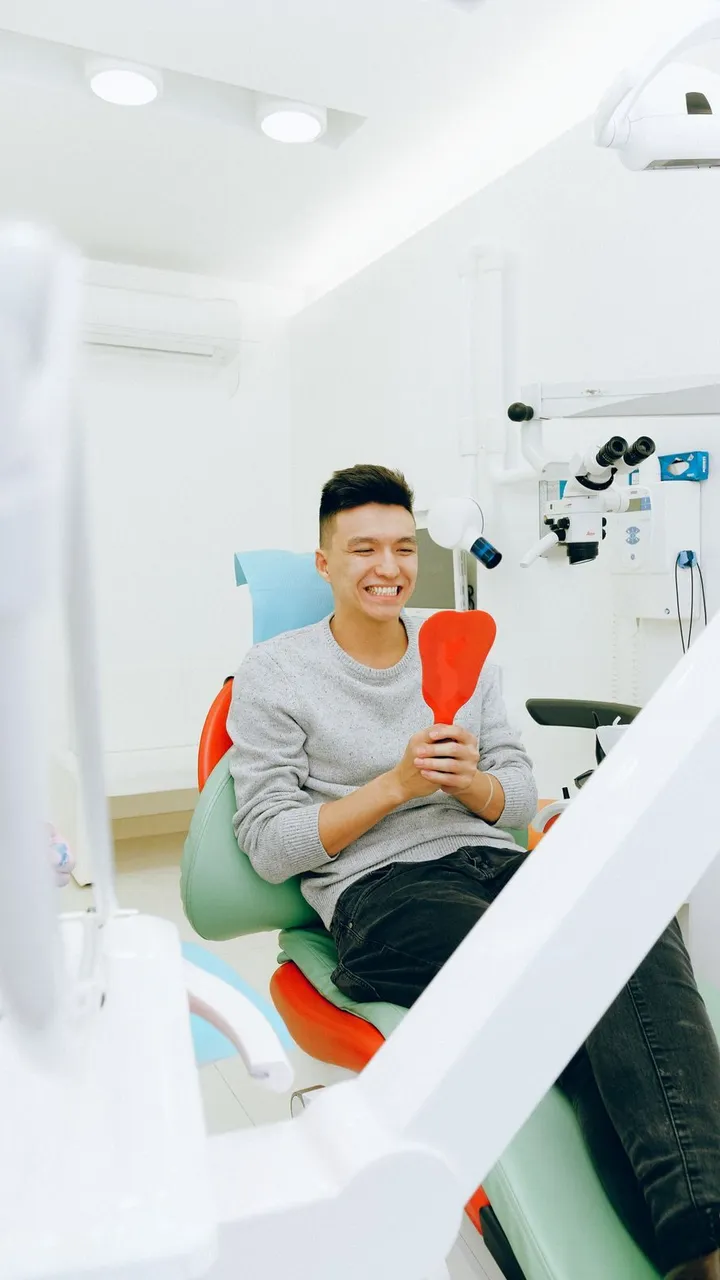 A patient smiling in the dental chair