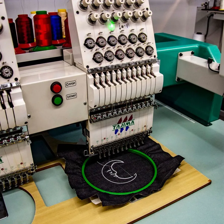 An embroidery machine stitching a logo